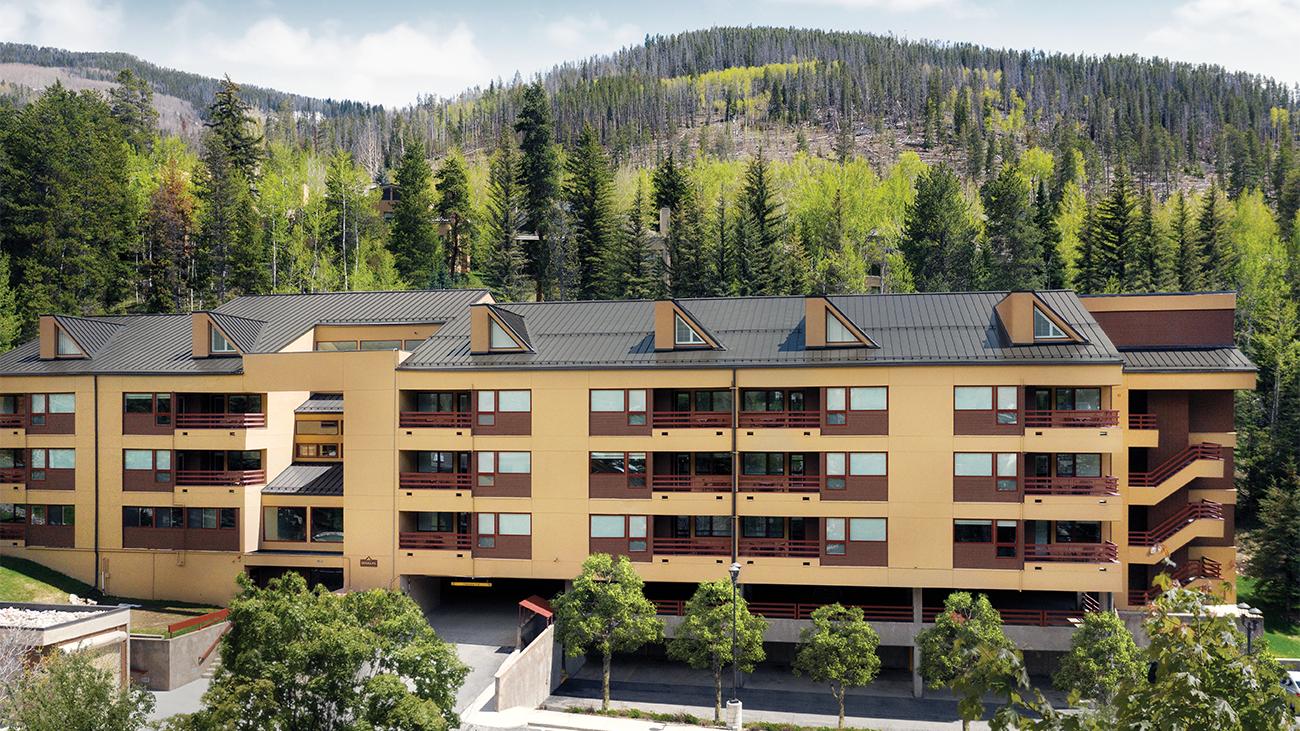 Exterior of Marriott's StreamSide Douglas resort timeshare with forested mountains in distance
